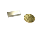 a gold coin and a silver bar on a black background