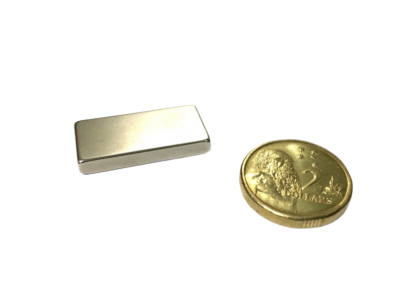 a gold coin and a silver bar on a black background