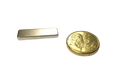 a gold coin and a silver bar on a black background