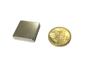 a gold coin sitting next to a lighter