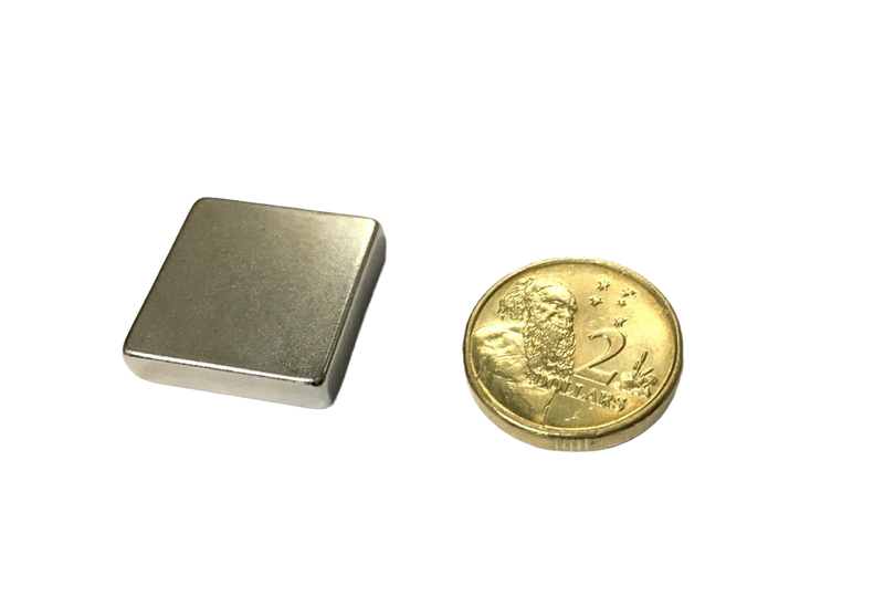 a gold coin sitting next to a lighter