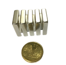 a small metal object next to a penny