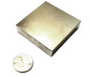 a small metal box next to a coin