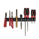 Magnetic tool rail in use, plier and snip handles hooked over the open front edge beside upright screwdrivers