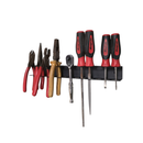 Magnetic tool rail mounted on a wall holding pliers, snips, a ratchet, two files and four screwdrivers