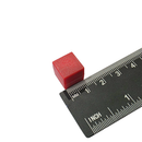 Red 13mm plastic coated neodymium block magnet shown against a measuring scale