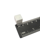 White 13mm plastic coated neodymium block magnet shown against a measuring scale