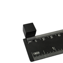 Black 13mm plastic coated neodymium block magnet shown against a measuring scale
