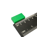 25.4mm x 12.7mm x 6.3mm green plastic coated neodymium block magnet shown beside a ruler for scale
