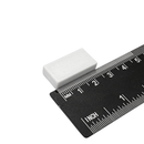 25.4mm x 12.7mm x 6.3mm white plastic coated neodymium block magnet shown beside a ruler for scale