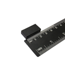 25.4mm x 12.7mm x 6.3mm black plastic coated neodymium block magnet shown beside a ruler for scale