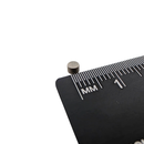 3mm x 2mm samarium cobalt disc magnet shown beside a ruler for scale