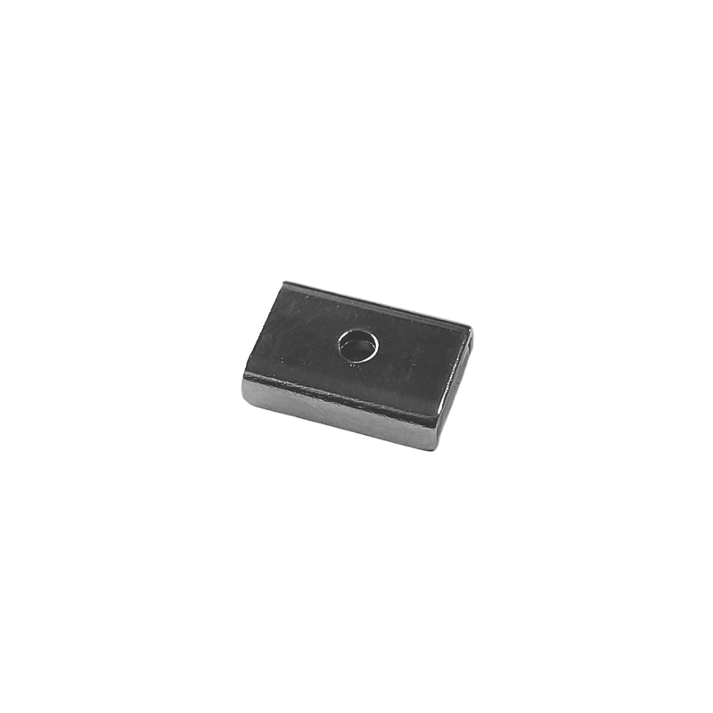 a square metal object sitting on top of a white surface