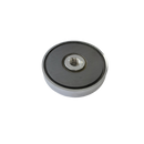 a round metal object with a black background