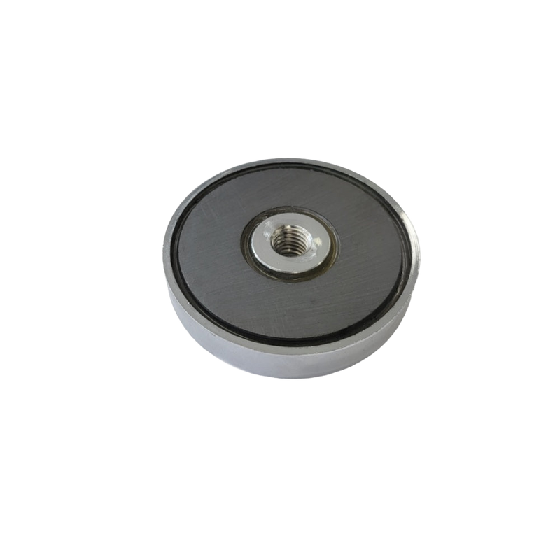 a round metal object with a black background