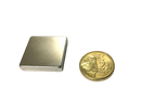 a gold coin sitting next to a metal box