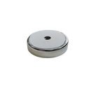 a round metal object on a black background