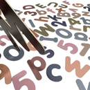 Close-up of magnetic letters and numbers in soft, muted colours