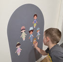 Child dressing magnetic characters on a magnetic arch wall decal